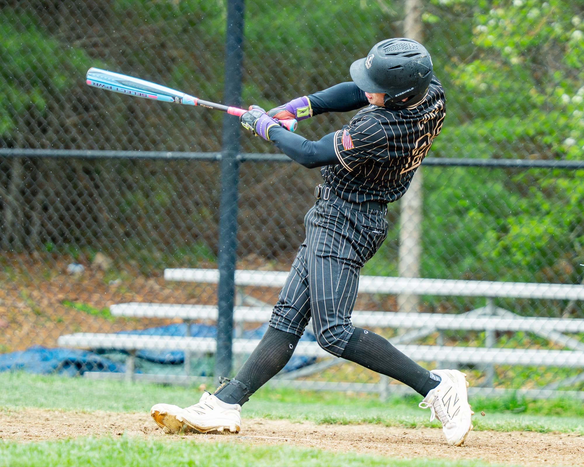 Ghost Premier hitter making contact in pinstripe uniform